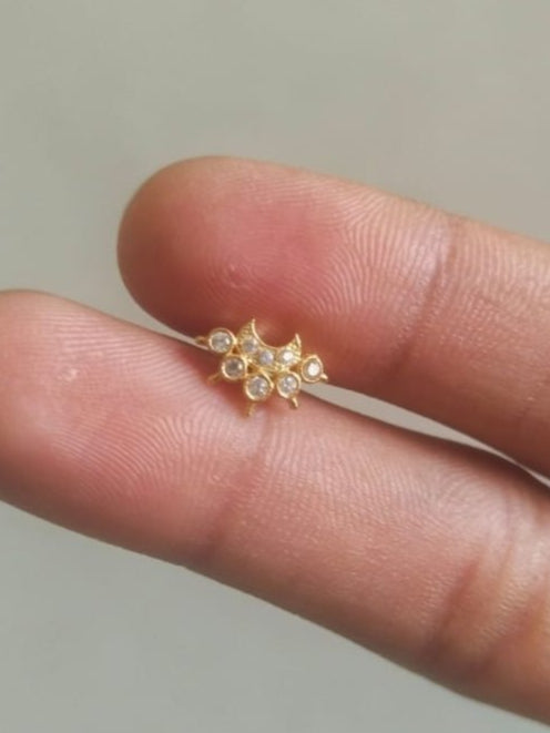 Silver nosepins featuring traditional motifs with a modern design twist, displayed on a neutral background.