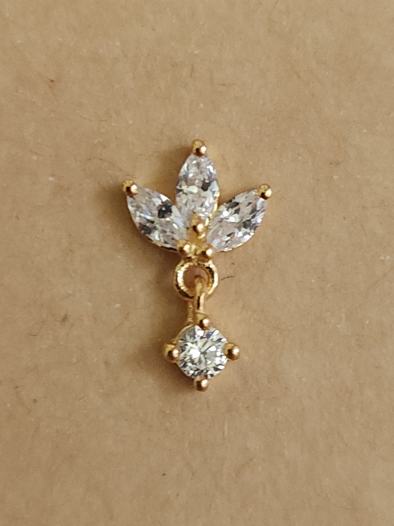 Silver nosepins featuring traditional motifs with a modern design twist, displayed on a neutral background.