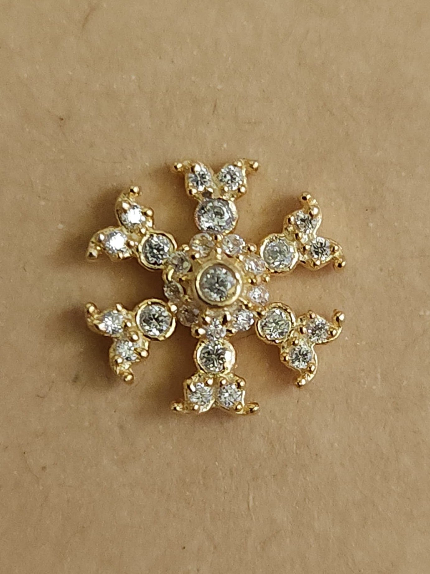Silver nosepins featuring traditional motifs with a modern design twist, displayed on a neutral background.