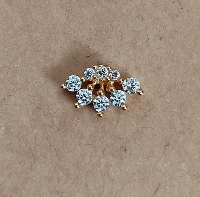 Silver nosepins featuring traditional motifs with a modern design twist, displayed on a neutral background.