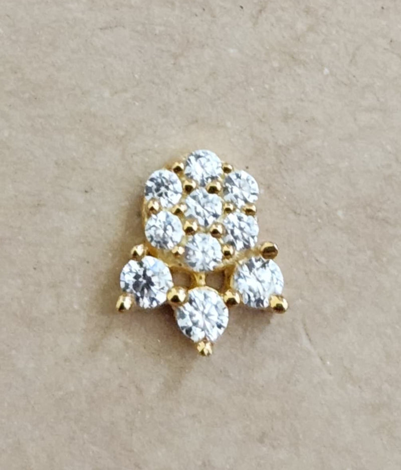 Silver nosepins featuring traditional motifs with a modern design twist, displayed on a neutral background.