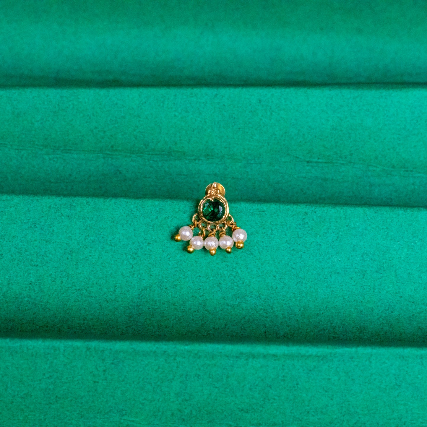 Silver nosepins featuring traditional motifs with a modern design twist, displayed on a neutral background.