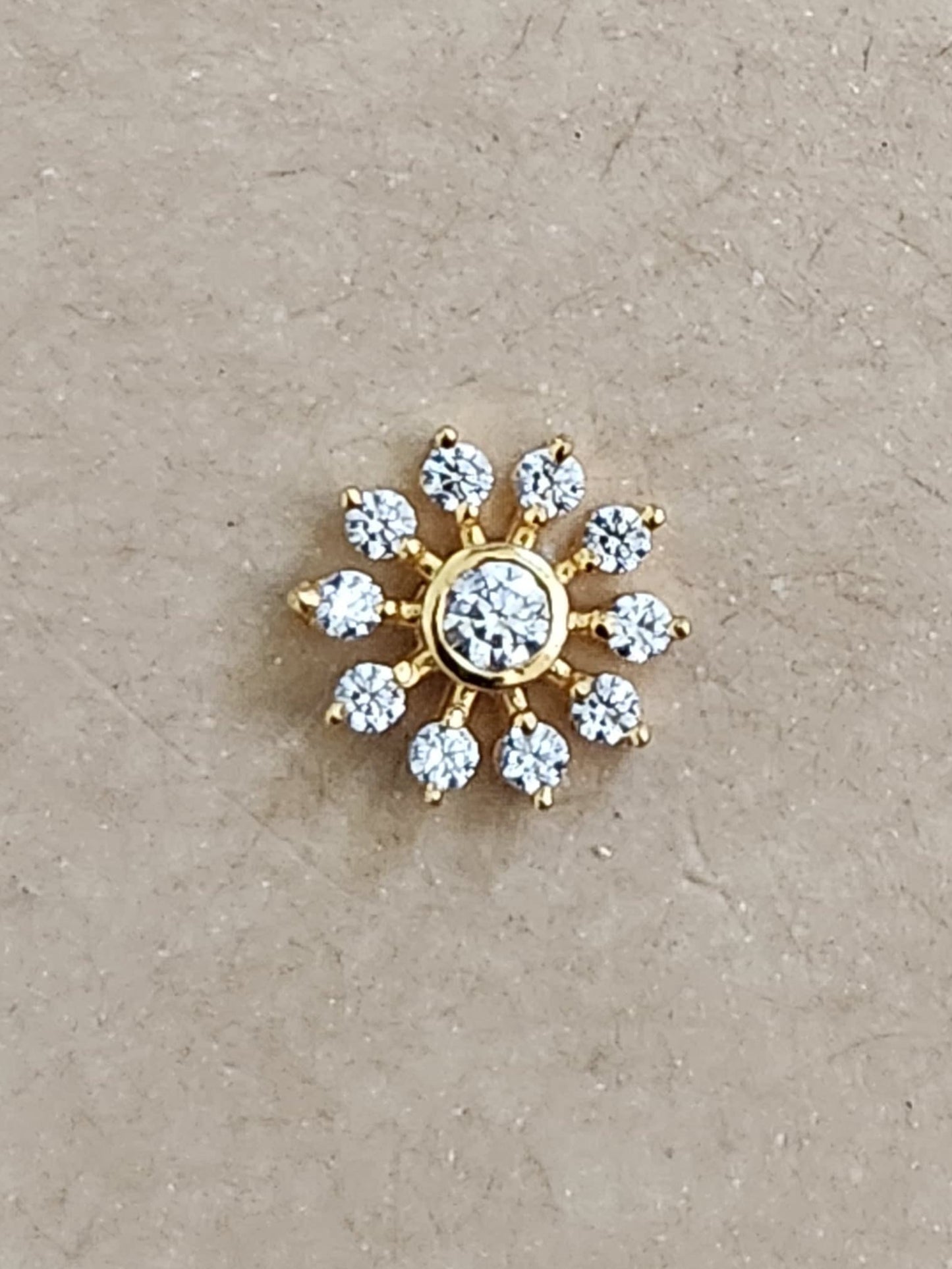 Silver nosepins featuring traditional motifs with a modern design twist, displayed on a neutral background.