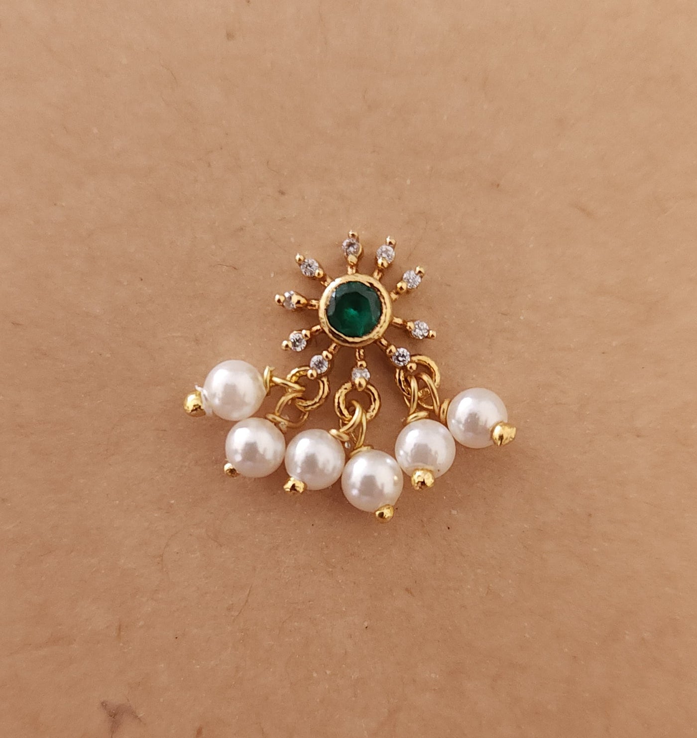 Silver nosepins featuring traditional motifs with a modern design twist, displayed on a neutral background.