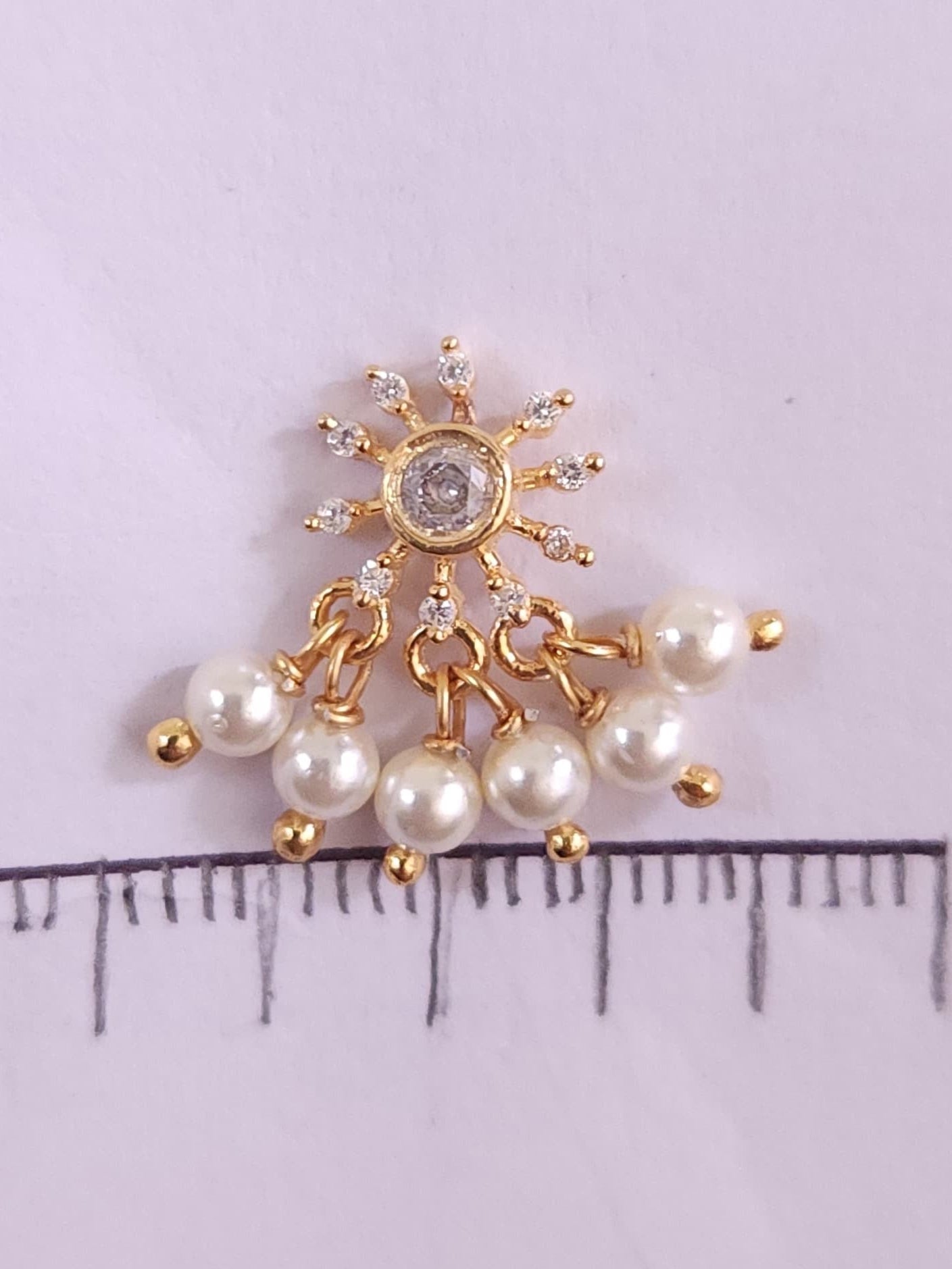 Silver nosepins featuring traditional motifs with a modern design twist, displayed on a neutral background.