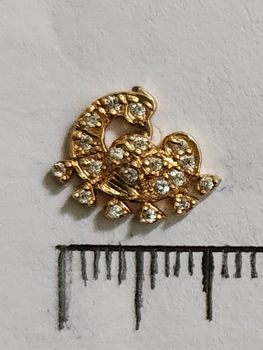 Silver nosepins featuring traditional motifs with a modern design twist, displayed on a neutral background.