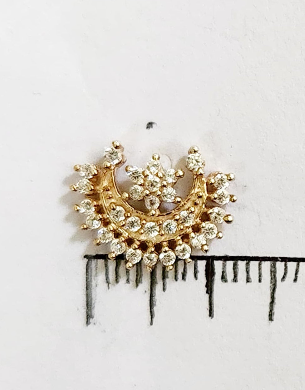 Silver nosepins featuring traditional motifs with a modern design twist, displayed on a neutral background.