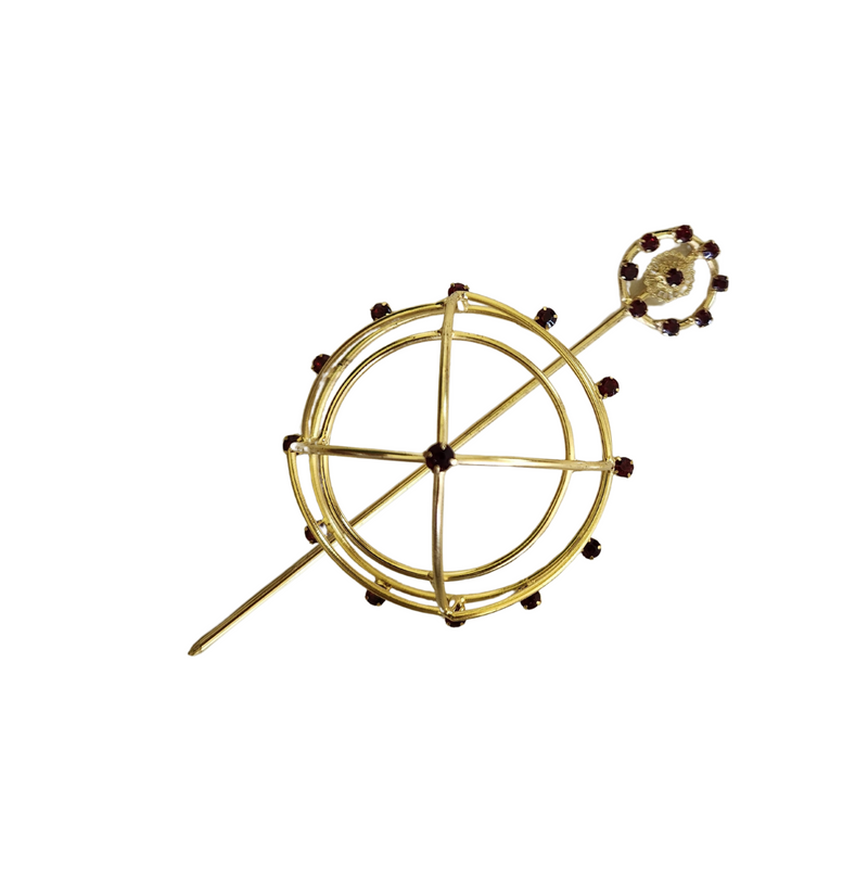Gold spiral hairbun with concentric circles and intricate design. Elegant and artistic, it conveys a sense of sophistication.