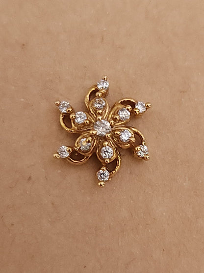 Silver nosepins featuring traditional motifs with a modern design twist, displayed on a neutral background.