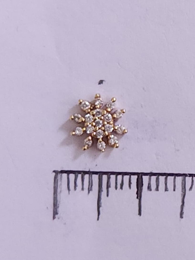 Silver nosepins featuring traditional motifs with a modern design twist, displayed on a neutral background.