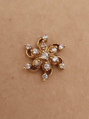 Silver nosepins featuring traditional motifs with a modern design twist, displayed on a neutral background.