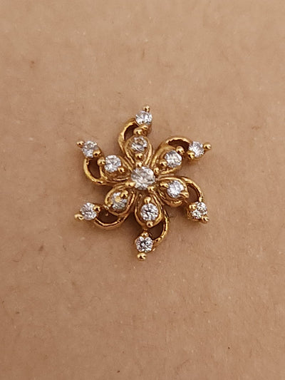 Silver nosepins featuring traditional motifs with a modern design twist, displayed on a neutral background.