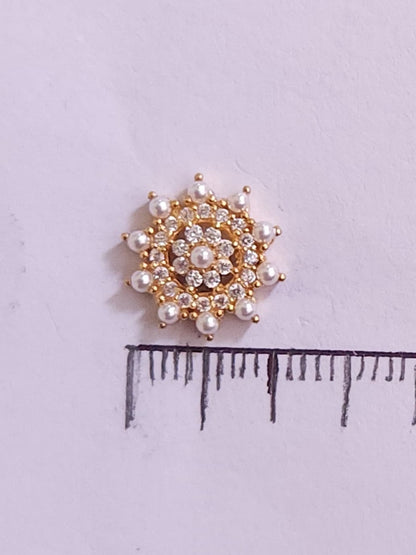 Silver nosepins featuring traditional motifs with a modern design twist, displayed on a neutral background.