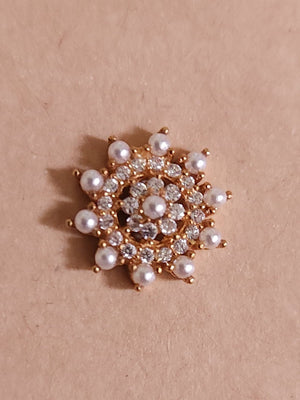 Silver nosepins featuring traditional motifs with a modern design twist, displayed on a neutral background.