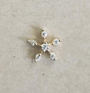 Silver nosepins featuring traditional motifs with a modern design twist, displayed on a neutral background.