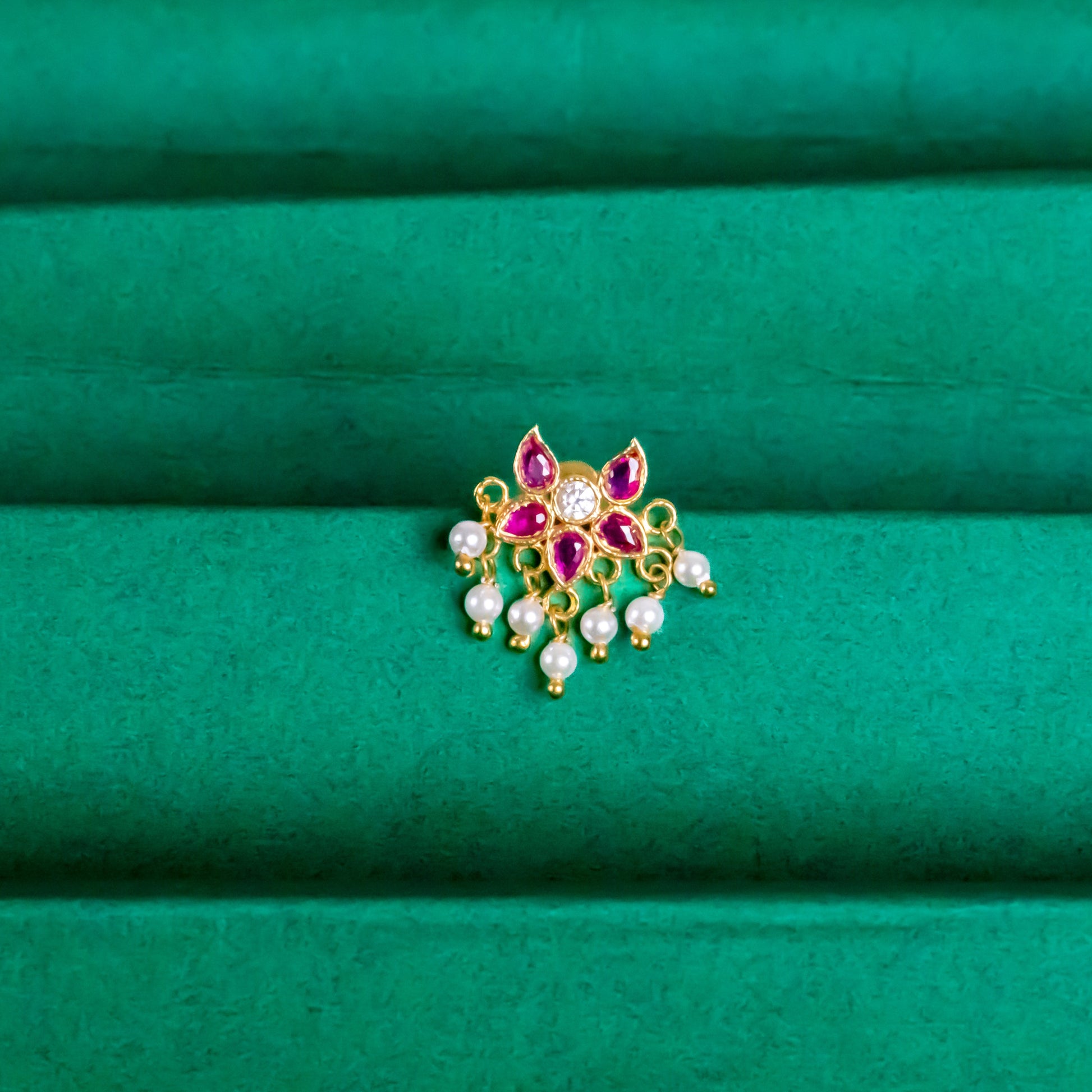 Silver nosepins featuring traditional motifs with a modern design twist, displayed on a neutral background.