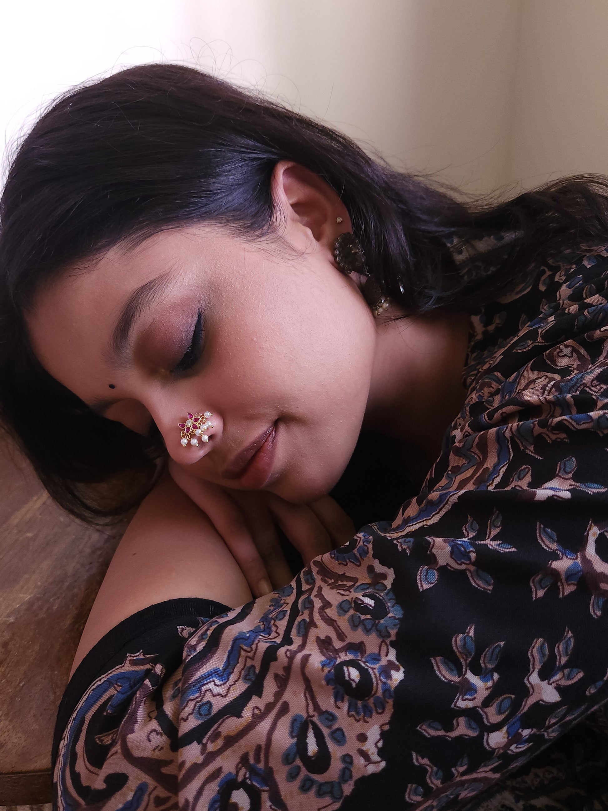 Silver nosepins featuring traditional motifs with a modern design twist, displayed on a neutral background.