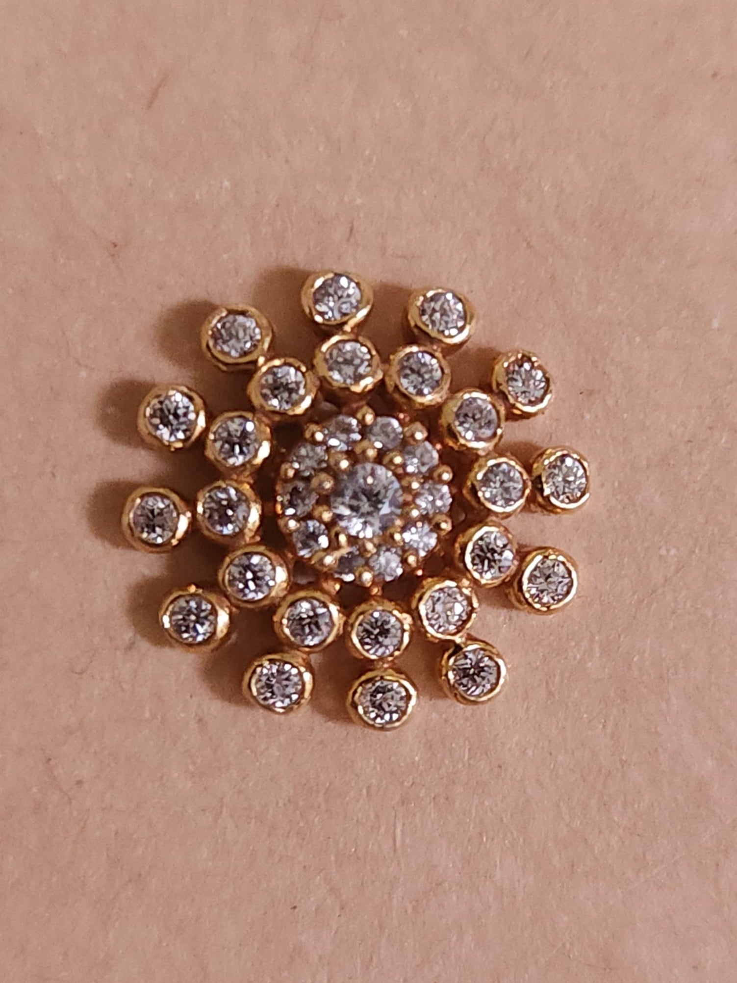Silver nosepins featuring traditional motifs with a modern design twist, displayed on a neutral background.