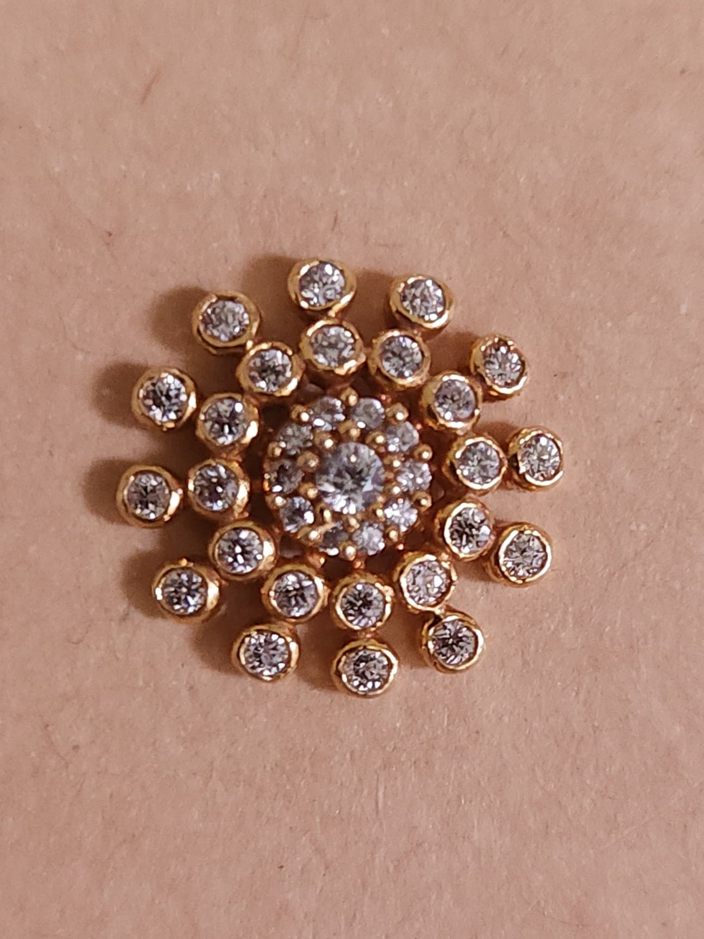 Silver nosepins featuring traditional motifs with a modern design twist, displayed on a neutral background.