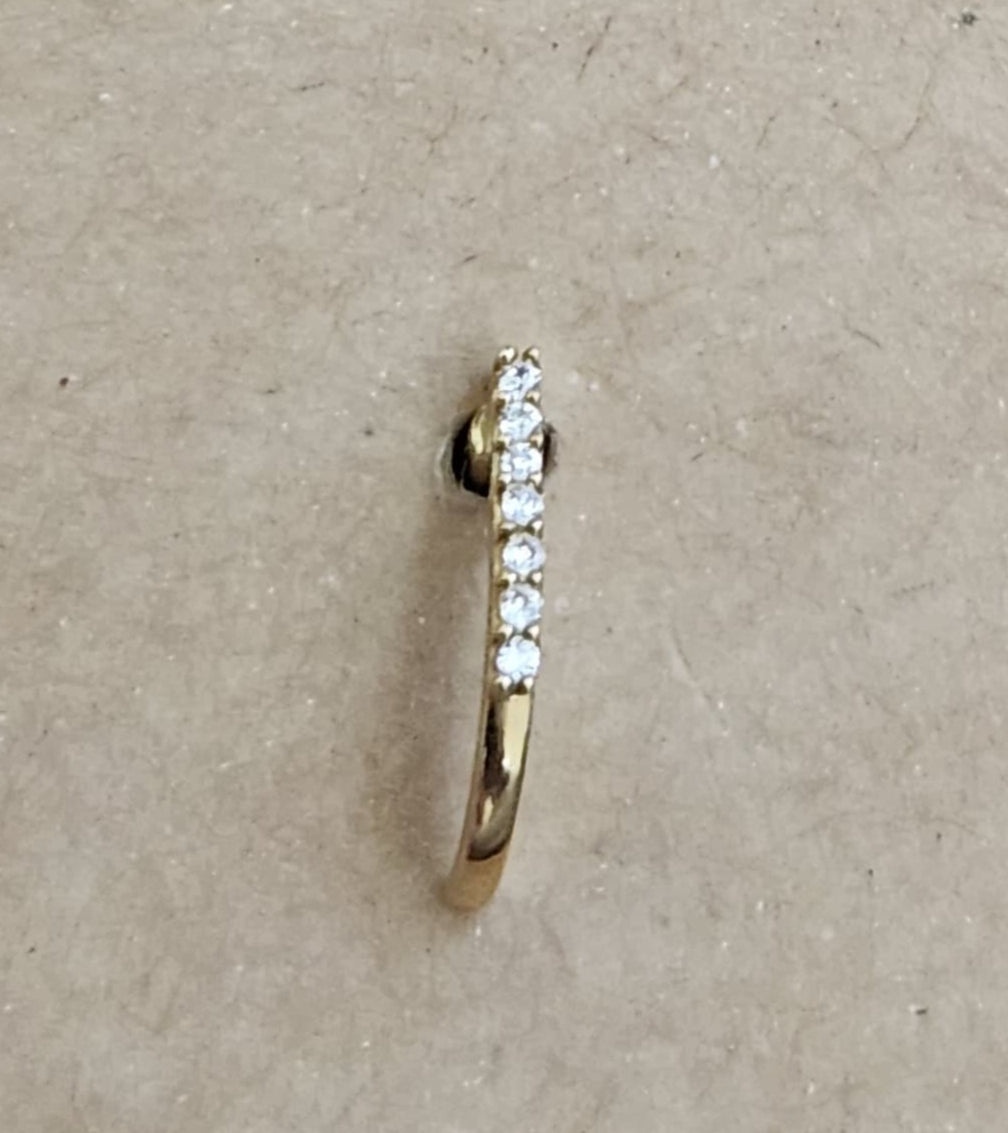 Silver nosepins featuring traditional motifs with a modern design twist, displayed on a neutral background.