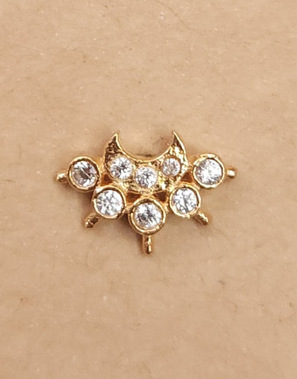 Silver nosepins featuring traditional motifs with a modern design twist, displayed on a neutral background.