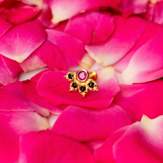 Silver nosepins featuring traditional motifs with a modern design twist, displayed on a neutral background.