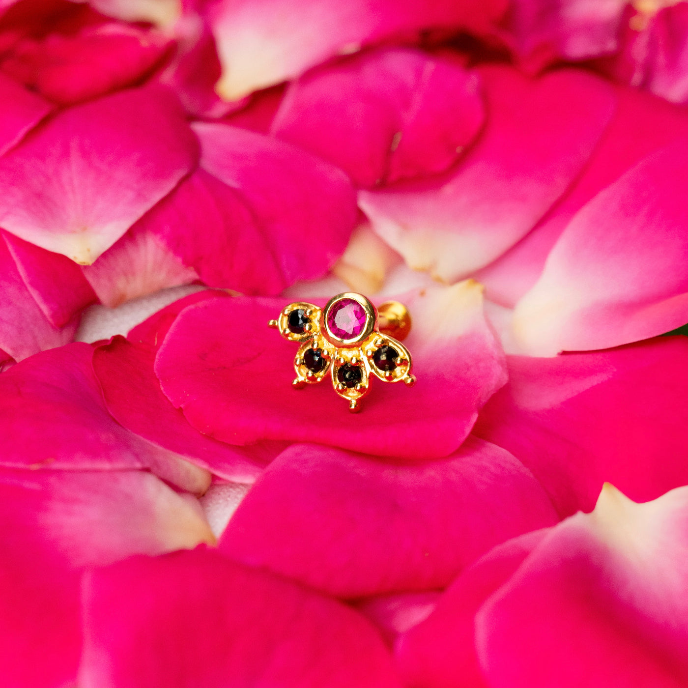 Silver nosepins featuring traditional motifs with a modern design twist, displayed on a neutral background.