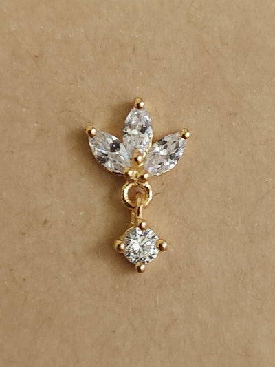 Silver nosepins featuring traditional motifs with a modern design twist, displayed on a neutral background.
