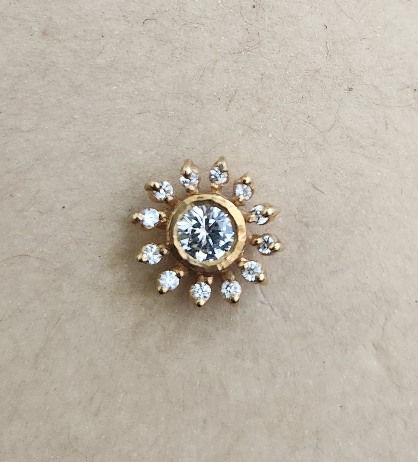 Silver nosepins featuring traditional motifs with a modern design twist, displayed on a neutral background.