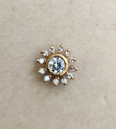 Silver nosepins featuring traditional motifs with a modern design twist, displayed on a neutral background.