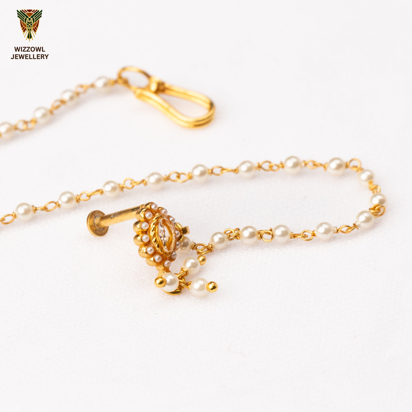 Silver nosepins featuring traditional motifs with a modern design twist, displayed on a neutral background.