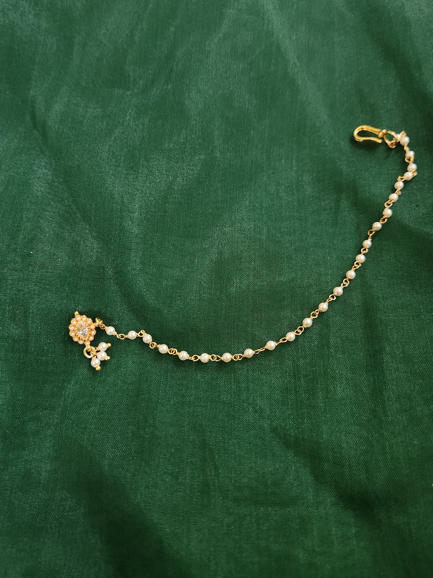 Silver nosepins featuring traditional motifs with a modern design twist, displayed on a neutral background.