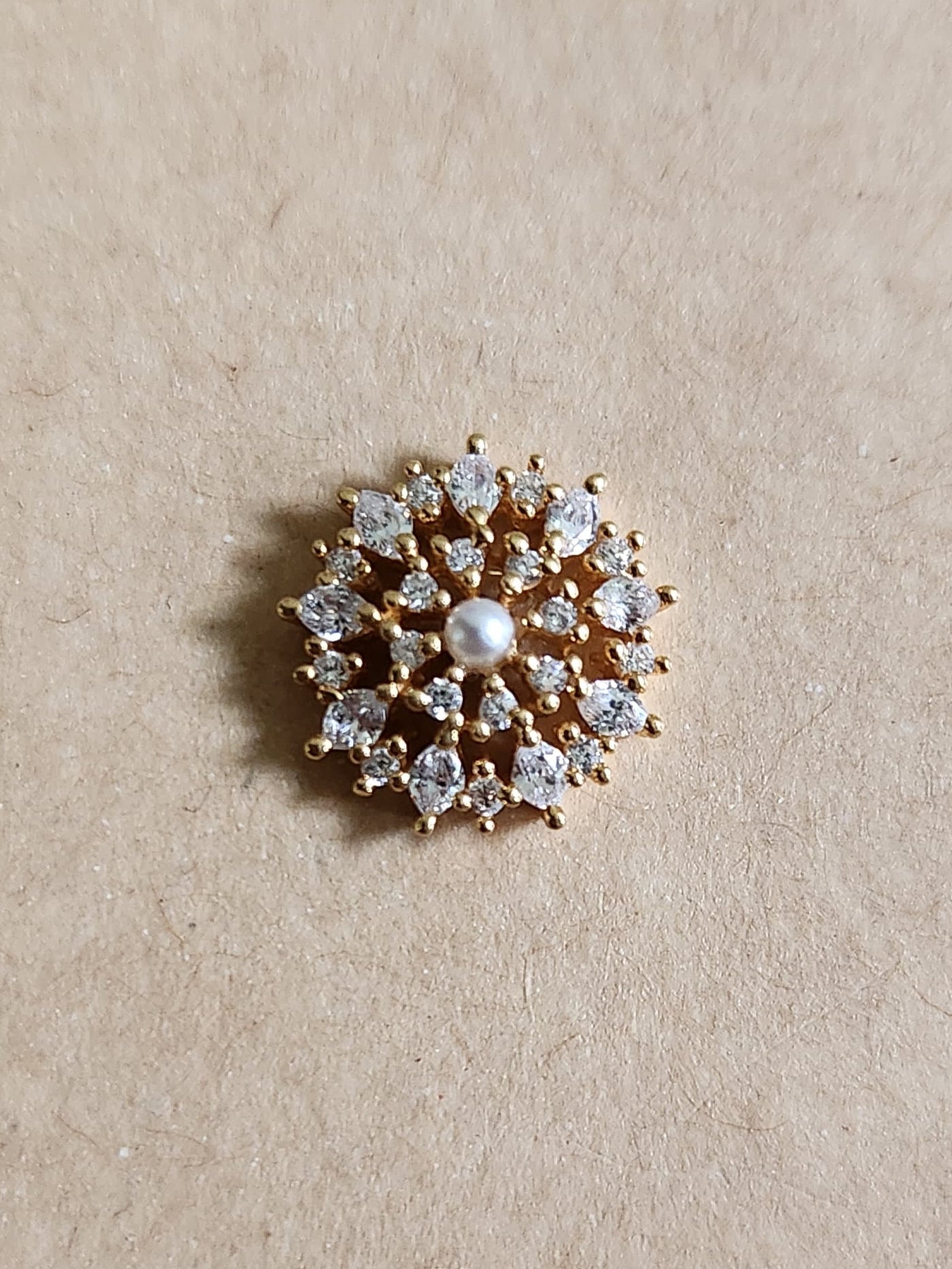 Silver nosepins featuring traditional motifs with a modern design twist, displayed on a neutral background.