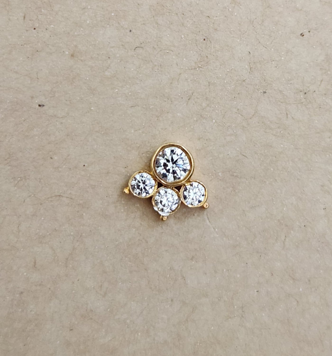 Silver nosepins featuring traditional motifs with a modern design twist, displayed on a neutral background.