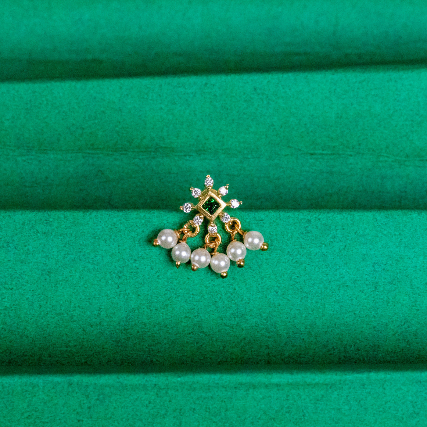 Silver nosepins featuring traditional motifs with a modern design twist, displayed on a neutral background.
