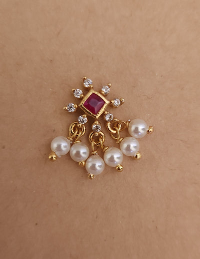 Silver nosepins featuring traditional motifs with a modern design twist, displayed on a neutral background.