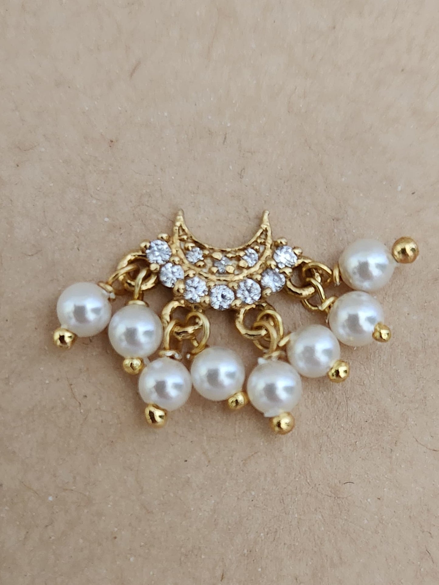 Silver nosepins featuring traditional motifs with a modern design twist, displayed on a neutral background.