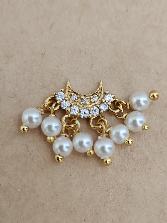 Silver nosepins featuring traditional motifs with a modern design twist, displayed on a neutral background.
