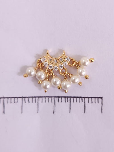 Silver nosepins featuring traditional motifs with a modern design twist, displayed on a neutral background.