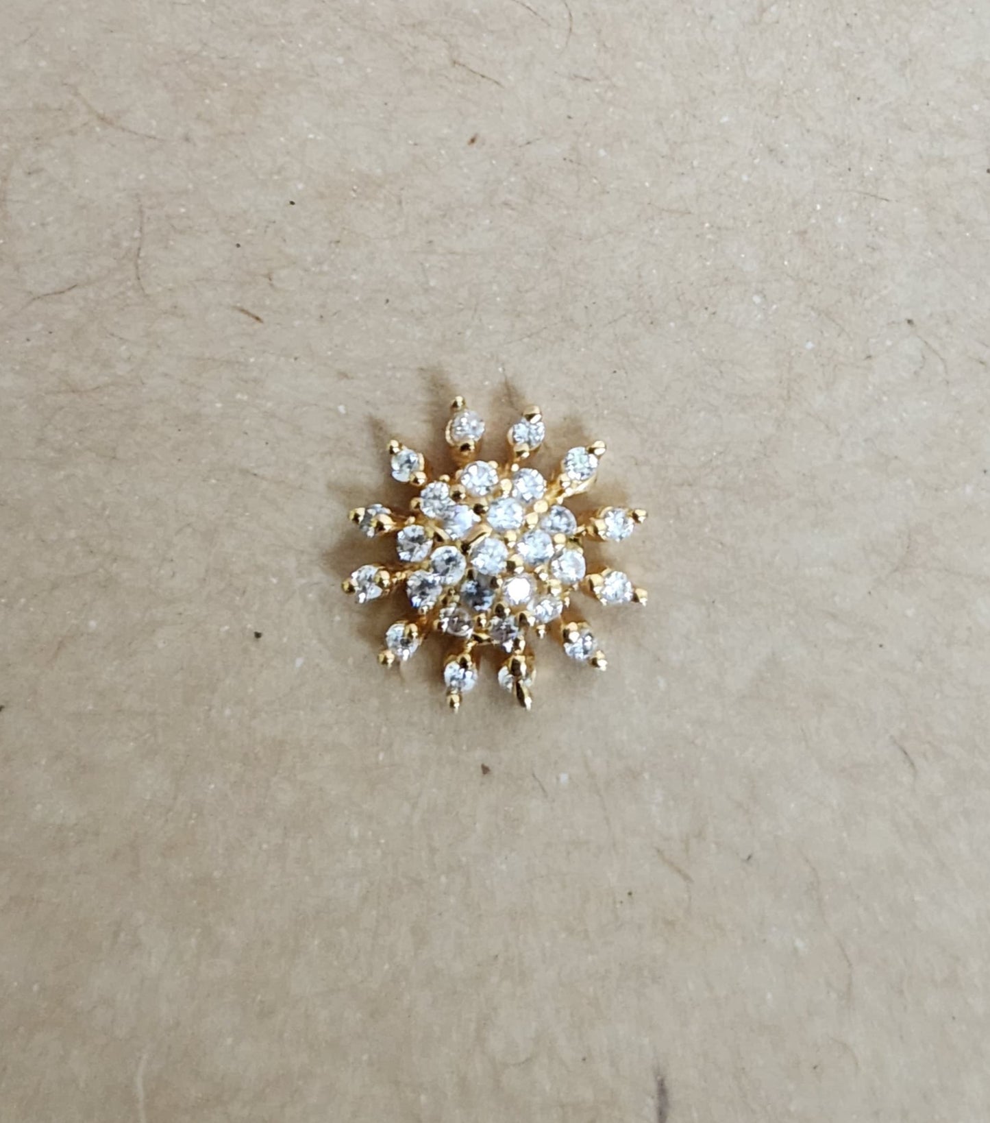 Silver nosepins featuring traditional motifs with a modern design twist, displayed on a neutral background.