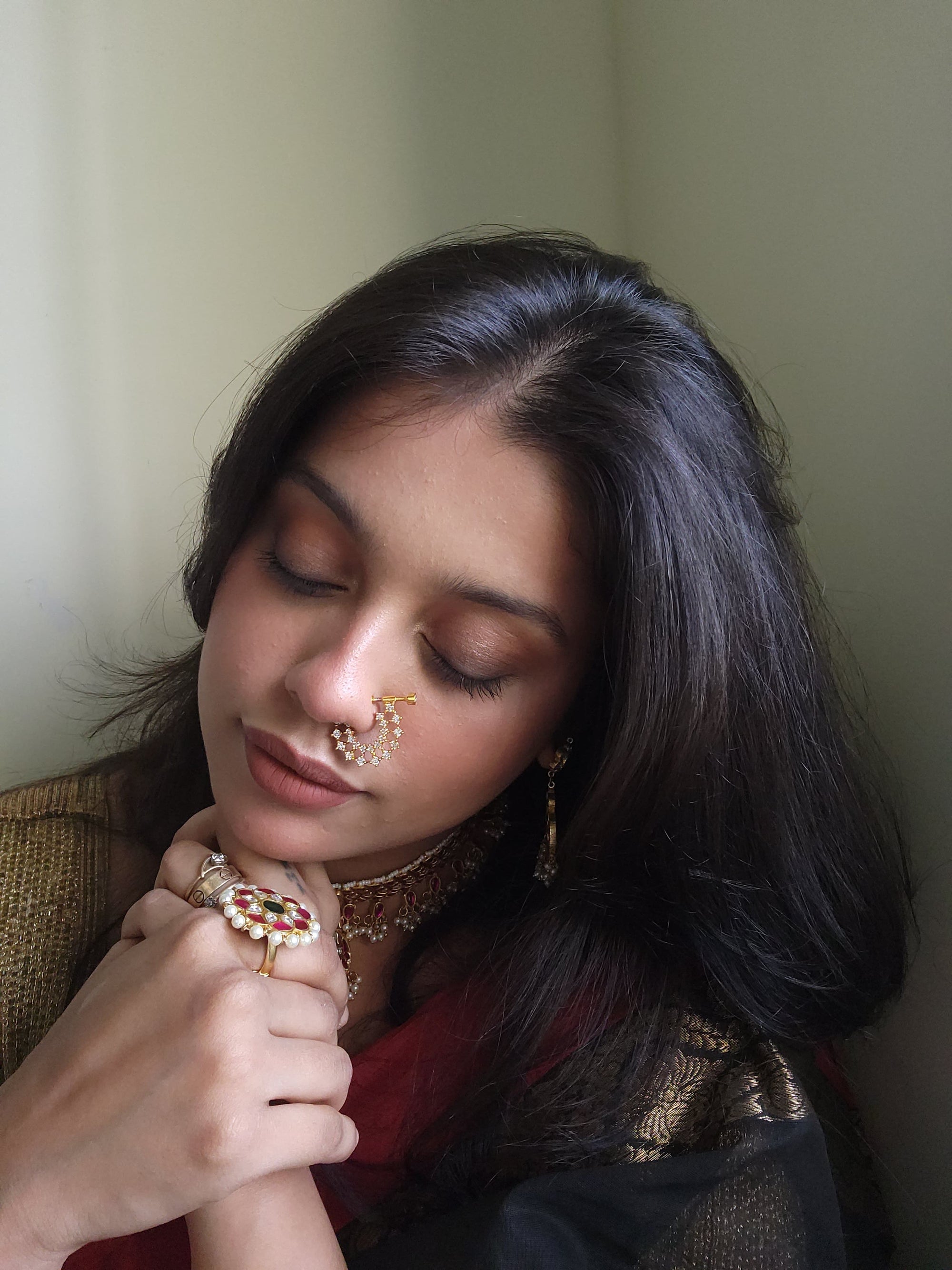 Silver nosepins featuring traditional motifs with a modern design twist, displayed on a neutral background.