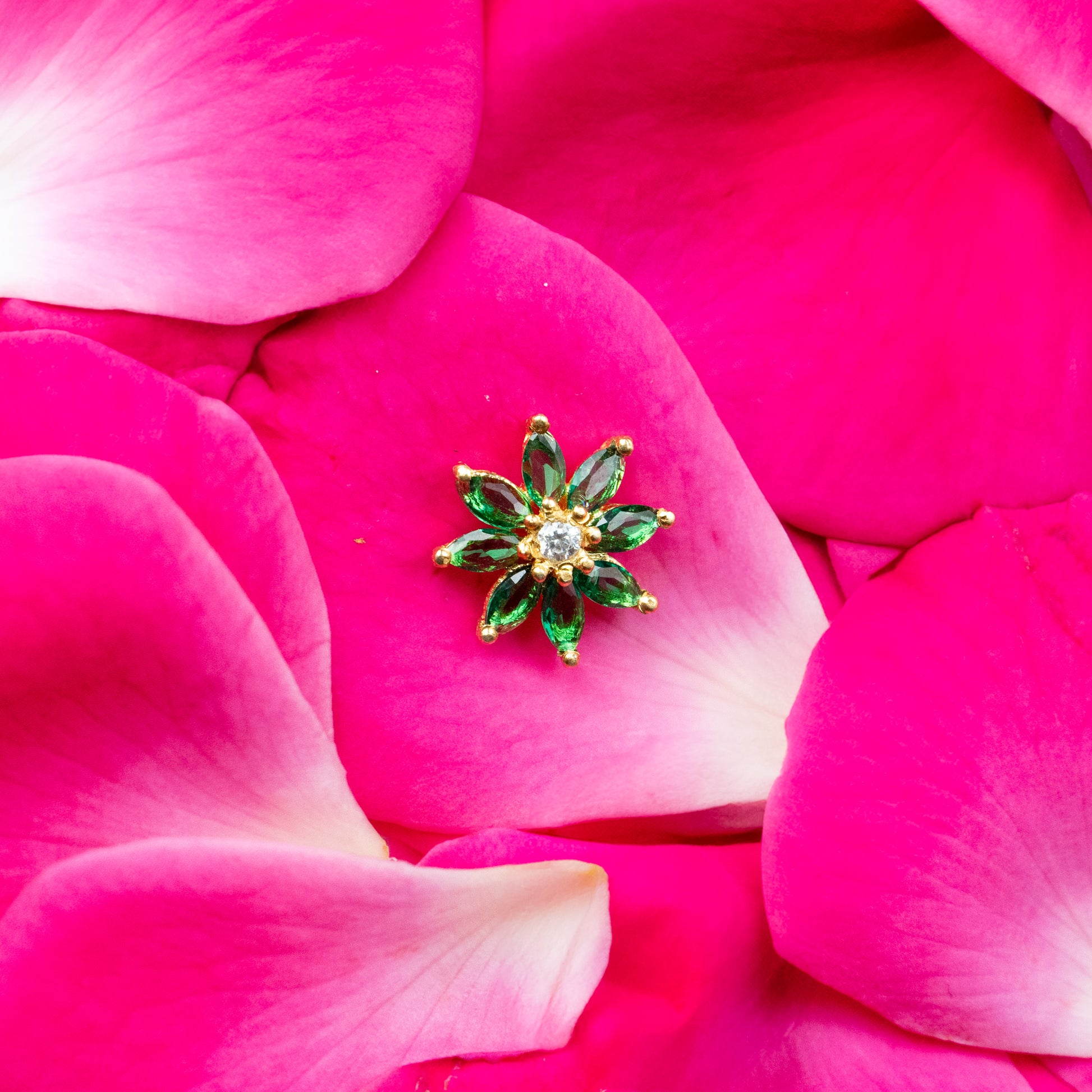 Silver nosepins featuring traditional motifs with a modern design twist, displayed on a neutral background.