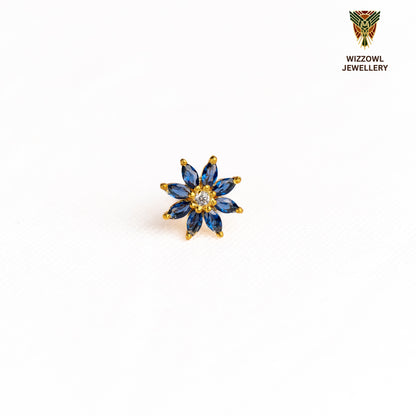 Silver nosepins featuring traditional motifs with a modern design twist, displayed on a neutral background.