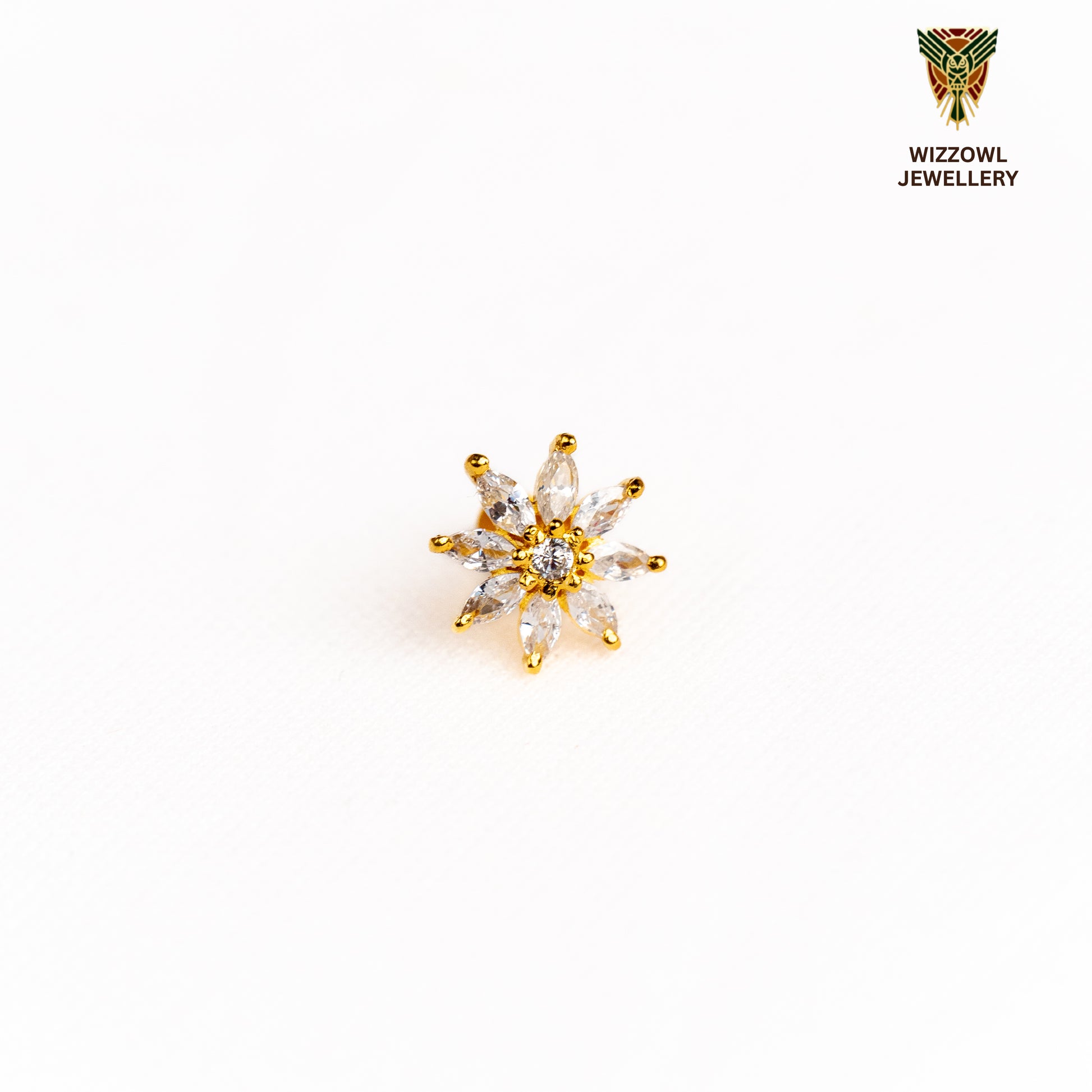 Silver nosepins featuring traditional motifs with a modern design twist, displayed on a neutral background.