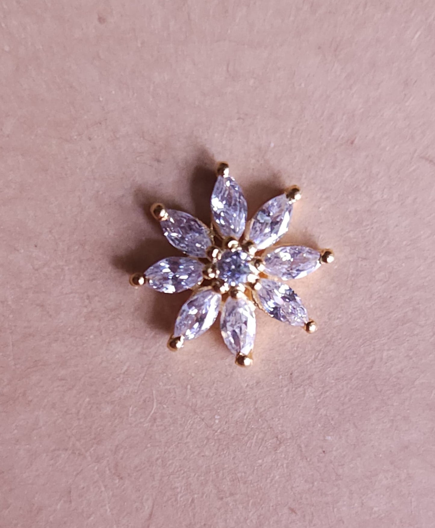 Silver nosepins featuring traditional motifs with a modern design twist, displayed on a neutral background.