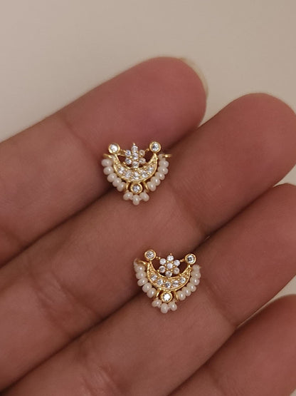 Silver nosepins featuring traditional motifs with a modern design twist, displayed on a neutral background.