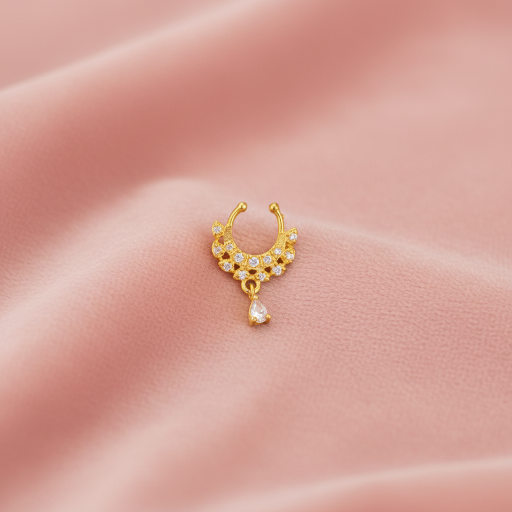 Gold-plated septum nosepin on blush pink velvet
