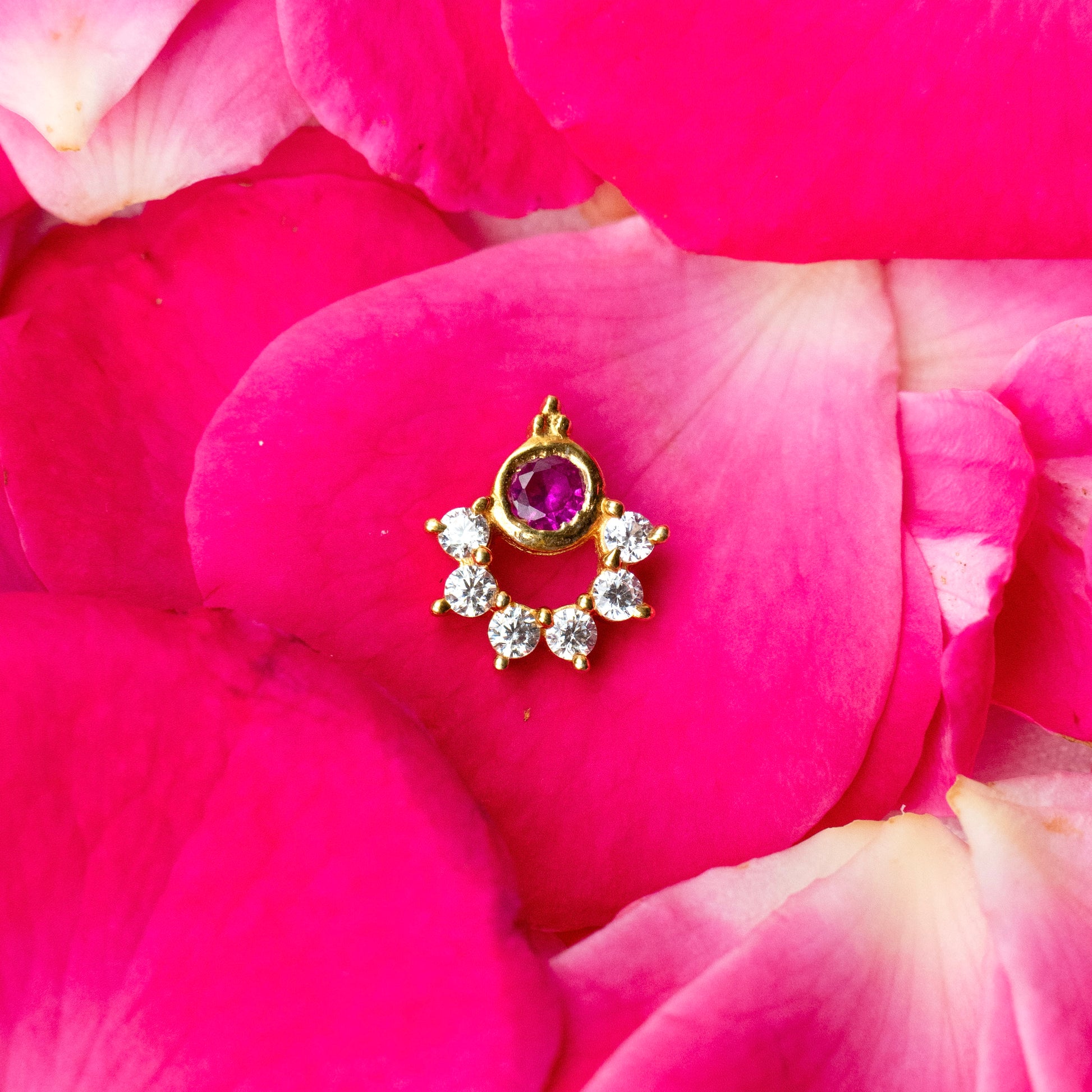 Silver nosepins featuring traditional motifs with a modern design twist, displayed on a neutral background.