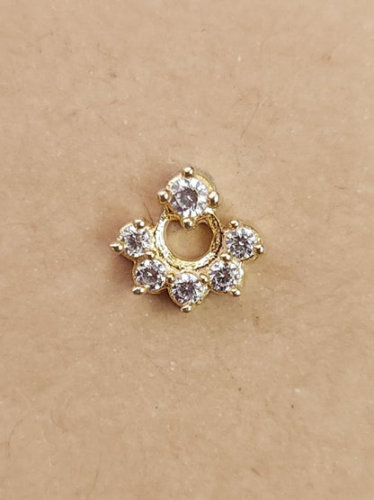 Silver nosepins featuring traditional motifs with a modern design twist, displayed on a neutral background.
