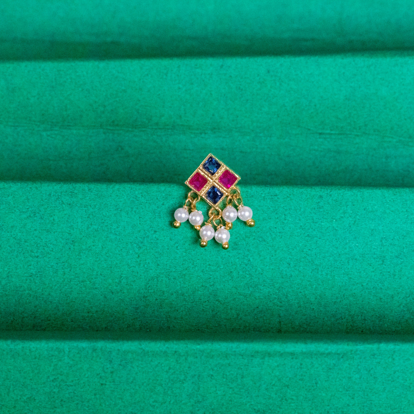 Silver nosepins featuring traditional motifs with a modern design twist, displayed on a neutral background.